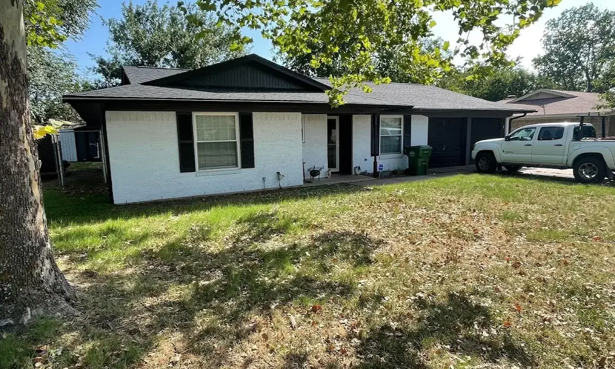 Professional roofing crew working on a residential roof in Worth